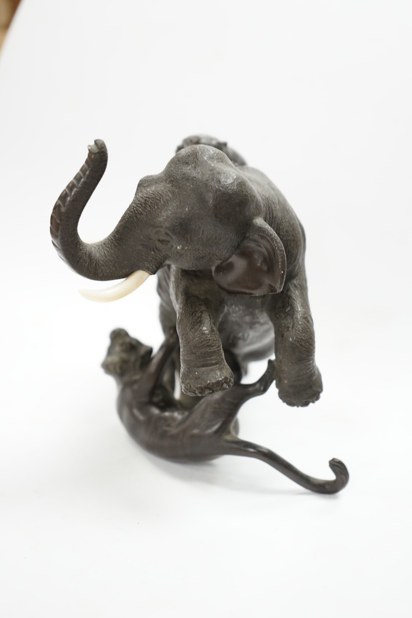 After Genryusai Seiya (1868-1912), a 19th century Japanese Meiji period cast bronze group of an elephant being attacked by tigers, seal mark, 14cm high. CITES Submission reference P5SHZWF1. Condition - good